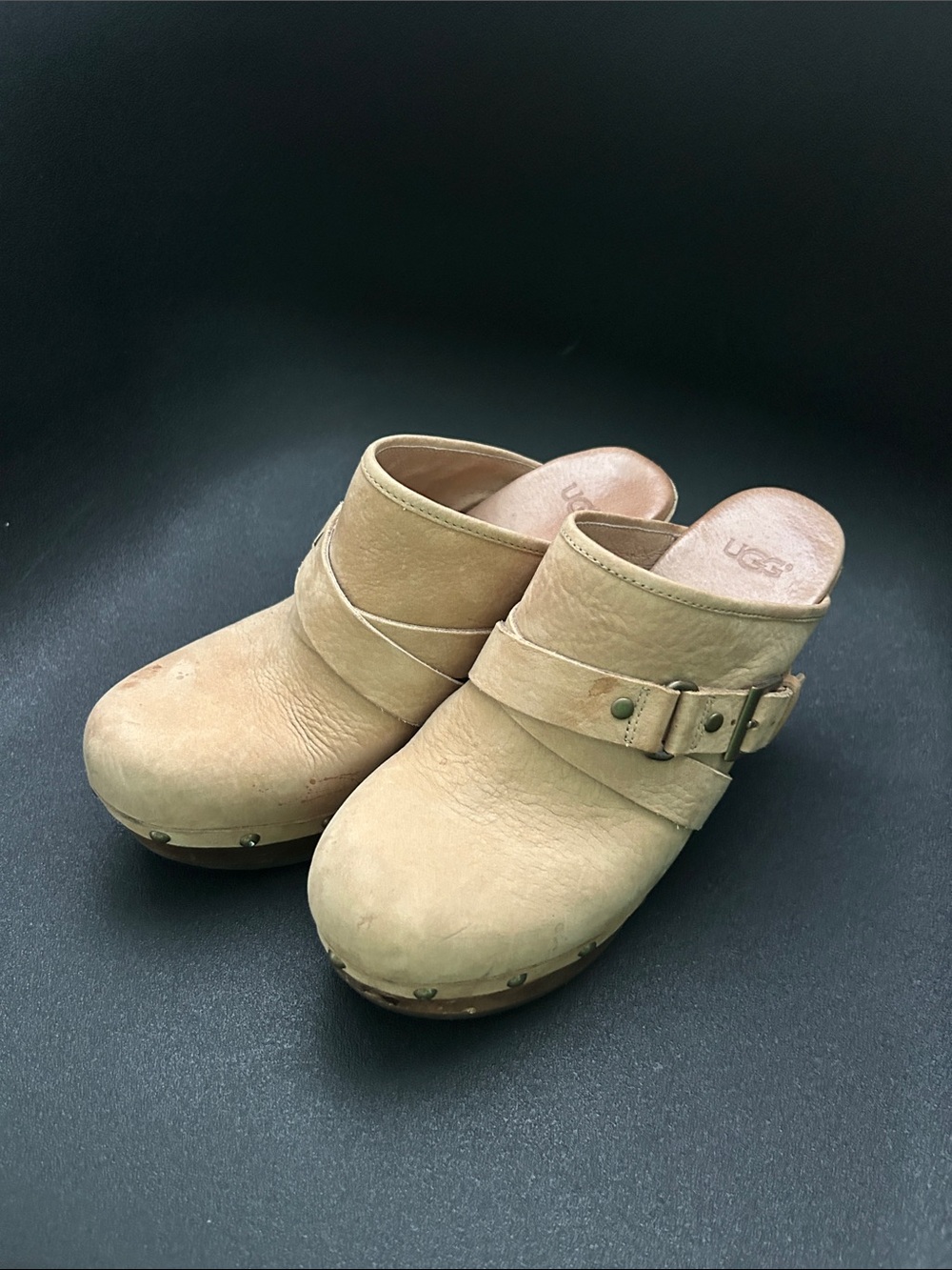 UGG Tan Suede Clog Mules with Side Buckle and faux fur lining.